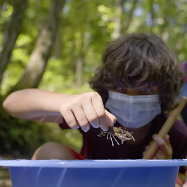 Sustainability - Four Rivers Sanitation Authority Child holding a crawfish